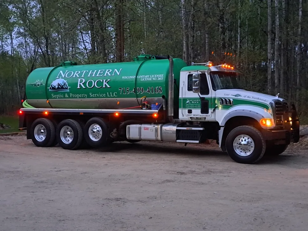Northern Rock pump truck parked at dusk in the Northwoods
